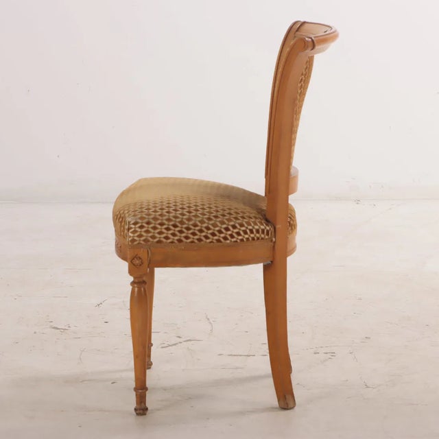 A refined set of eight French Directoire style dining chairs, dating to circa 1950, distinguished by their elegant tapered...