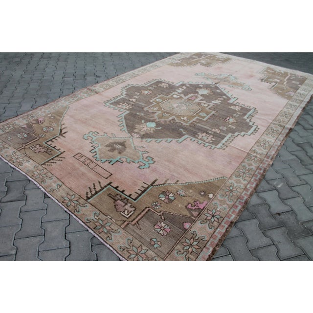 This beautiful, traditional vintage, hand knotted Turkish rug is approximately 60 years old. It is handmade of very fine...