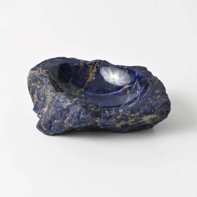 Small stone bowl with roughly finished edge. Made of sodalite, blue stone very similar to lapis lazuli.