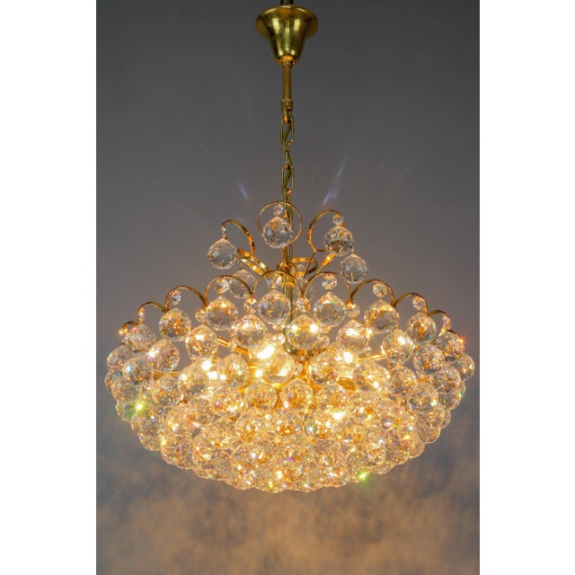 Crystal Glass and Gilt Brass Seven-Light Chandelier, made in Germany, in the late 1970s, is attributed to Christoph Palme....