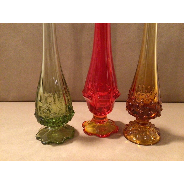 Add timeless elegance to your home with this **Vintage Mid-Century Modern Fenton Hobnail Swung Glass Single Bud Vase...
