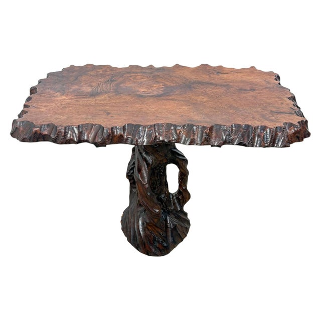 Exceptional hand-carved organic side table, most likely crafted from camphor wood, featuring a sculptural naturalistic...