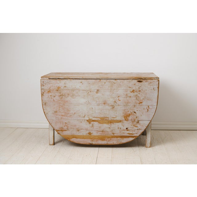 Large drop leaf table made by hand in solid pine during the mid 1800s in northern Sweden, circa 1850 to 1860. The table is...