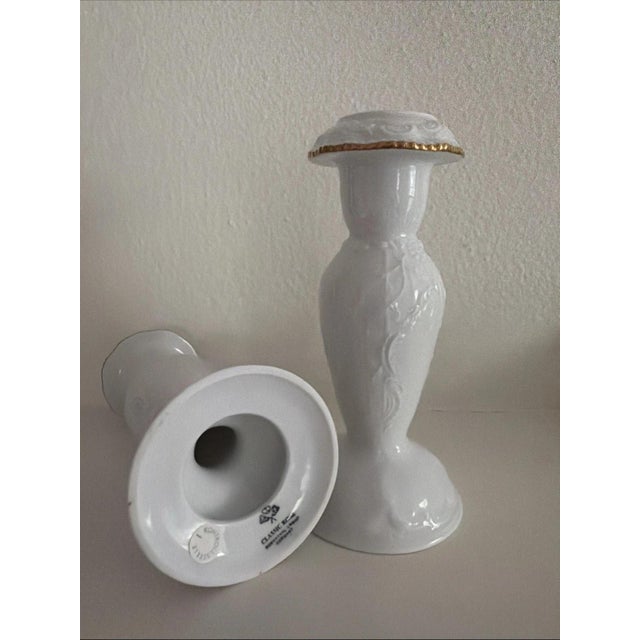 This is a pair of white, embossed Rosenthal Classic Rose Candle Stick Holders, made of bone china with gold accents. With...
