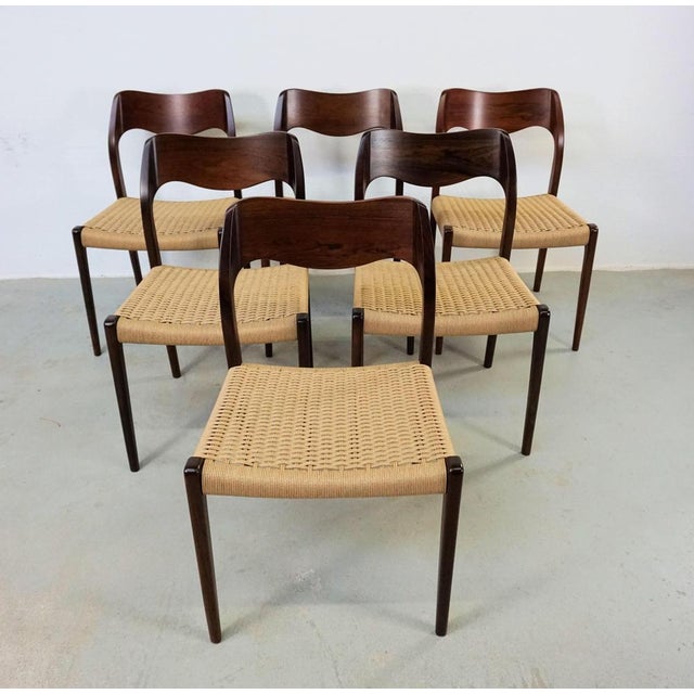 1960s Niels Otto Møller six rosewood dining chairs with new paper cord seats designed by Niels Otto Møller in 1951. The...