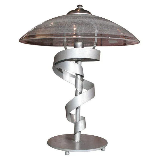 Moderne silver painted desk lamp with glass shade.