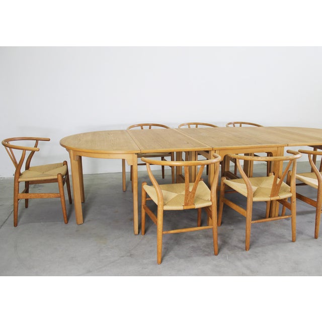 A living room set composed of an oval-shaped oak gateleg table with metal details, designed by borge mogensen and produced...