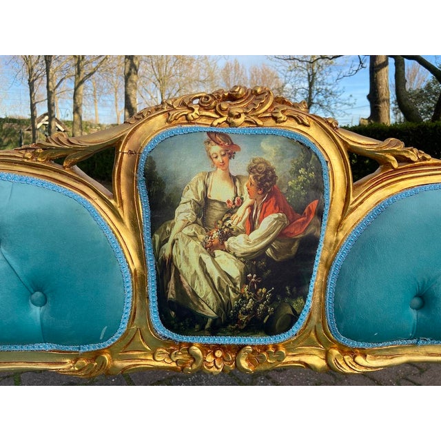 A charming 1970 French Louis XVI-style corbeille settee, beautifully designed with a gilded beechwood frame, rich blue...