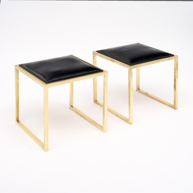 Pair of stools from France in the modernist style. Each stool has a strong brass structure and supports a square seat of...