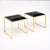 Pair of stools from France in the modernist style. Each stool has a strong brass structure and supports a square seat of...