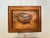 This 1975 vintage oil depicts a singular bird nest with a trio of eggs in robins egg blue on a singular branch. This light...