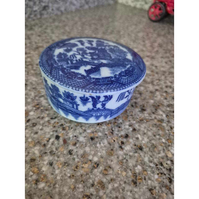 Featuring a vintage blue and white ceramic trinket box with the classic Blue Willow pattern. Pattern: The design is the...