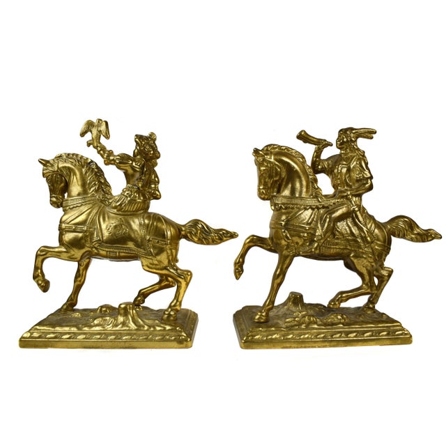 A pair of gold brass Renaissance style horsemen bookends sculpted, The pieces depict two prancing horses with riders; one...
