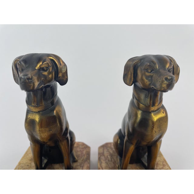 Pair of Art Deco dog bookends signed Jamar, produced circa 1930s. The seated dogs are rendered in a restrained animalier...