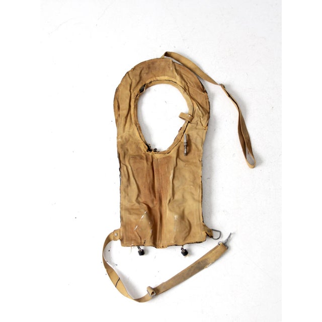 This original WWII-era Type B pneumatic life vest was manufactured by the Seamless Rubber Company and is dated 1945....
