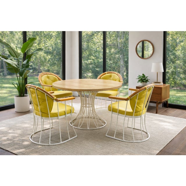 A striking 1960s patio dining set attributed to Max Stout of The Blacksmith Shop, featuring a sculptural wrought iron base...