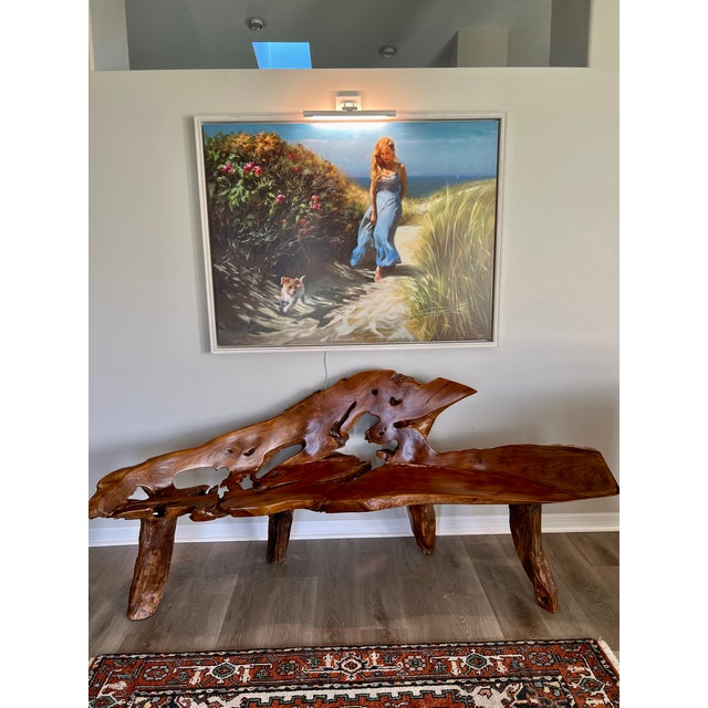 A striking one-of-a-kind sculptural teak bench featuring an extraordinary natural live-edge form and richly figured wood...