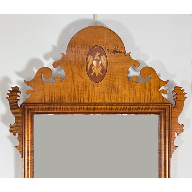 A hand crafted tiger maple mirror in the Chippendale style, with a Federal eagle crest, by the acclaimed New Hampshire...