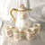 This is a Limoges chocolate pot with four matching cups. The pot and cups have two backstamps-an Elite Limoges backstamp...