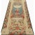 Vertical handwoven wool tapestry with ivory, coral and blue colors featuring female figure on pedestal surrounded by...