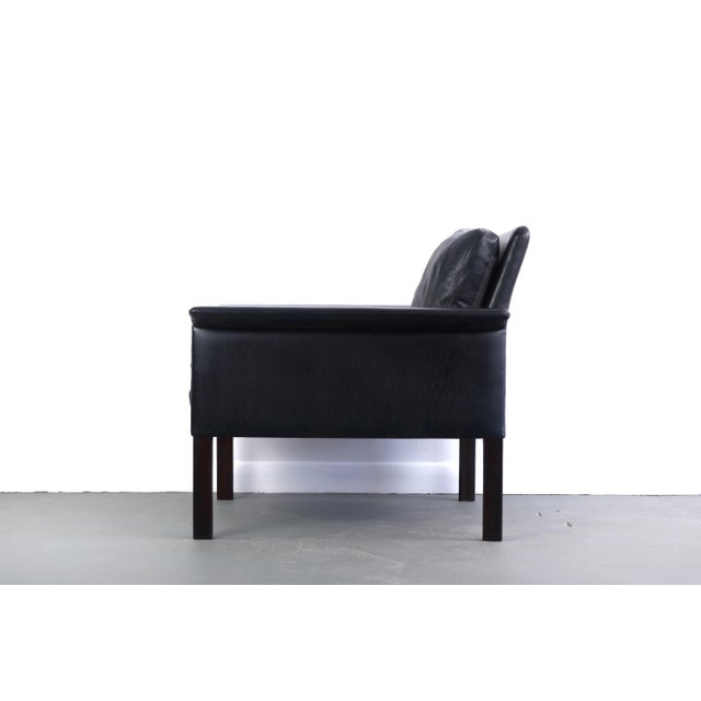 Perfectly worn in black leather and rosewood model #500 lounge chair by Hans Olsen for CS Møbler Glostrup. Made in...