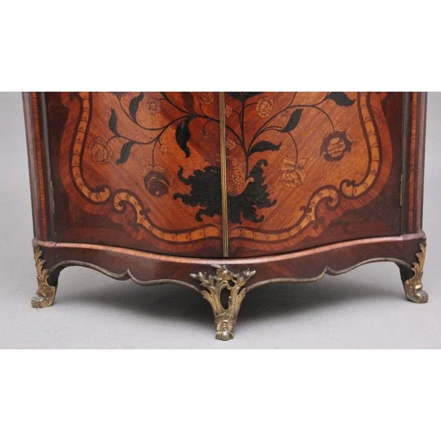 18th century French inlaid tulipwood and marble top corner cupboard, with a shaped and moulded edge rouge marble top above...