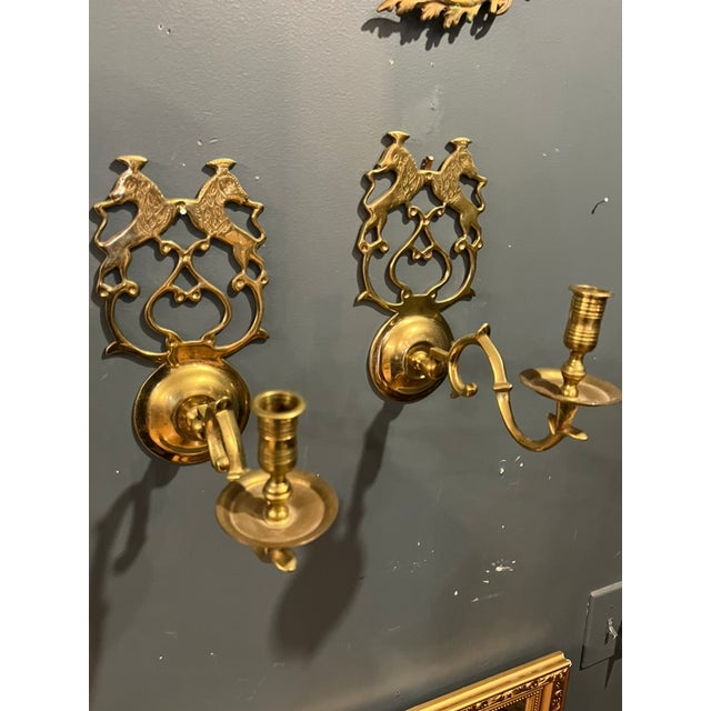 A pair of beautiful vintage brass candle sconces with a lion royalty crest motif. Very regal and stylish. Sconces can be...