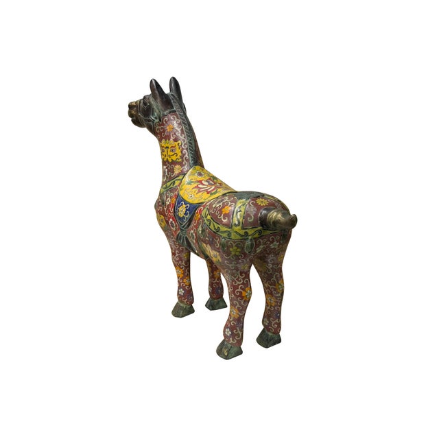 This striking bronze horse sculpture showcases a remarkable integration of metalwork and vibrant cloisonné enameling. The...
