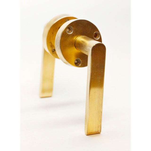 Bronze modern style lever doorknob with a polished finish and matching rosettes. Set includes two levers, two rosettes and...