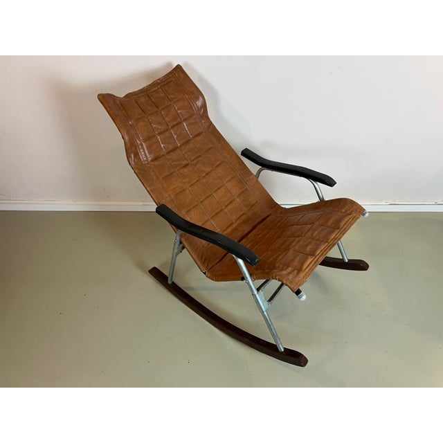 Vintage rocking chair by Takeshi Nii from Japan, 1950s. Made of aluminum, wood, and leather. The chair is foldable and...