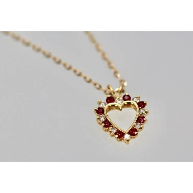 This is part of Chairish’s Fine Jewelry assortment. Ruby Diamond Open Heart Pendant on 17″ Yellow Gold Chain 18K I have...