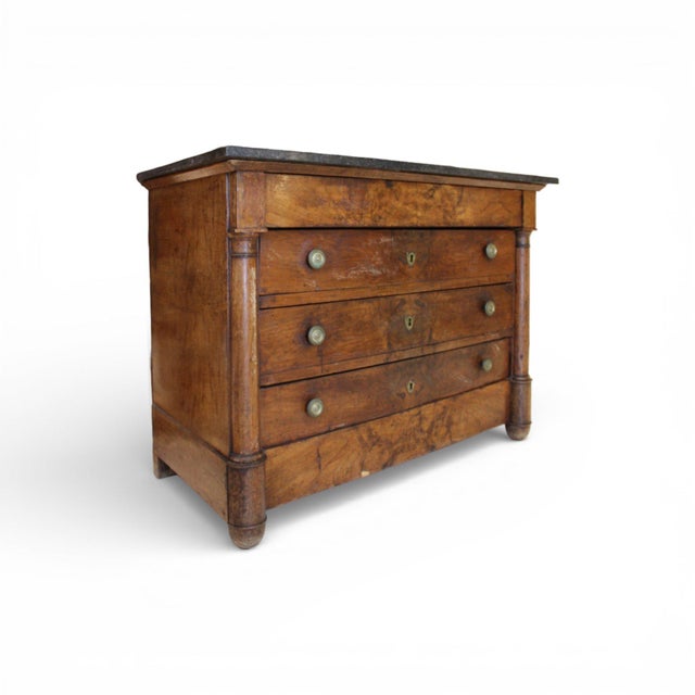 This 19th-century French walnut Empire chest showcases the period’s signature balance of strength and refinement. Framed...