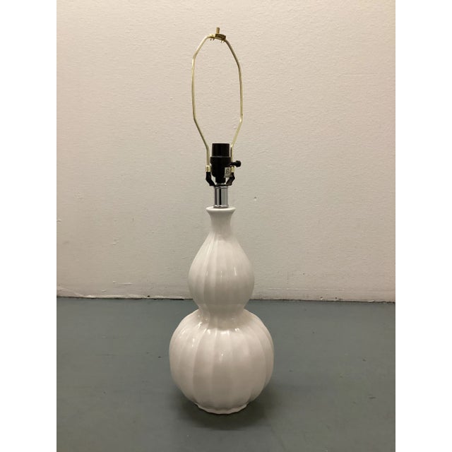 Large Midcentury white ceramic table lamp. Wired for the US and in working condition. Lamp uses a standard 100 watt bulb....