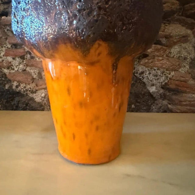 This striking 1990s Modernist German ceramic vase serves as a bold example of the enduring "Fat Lava" tradition,...