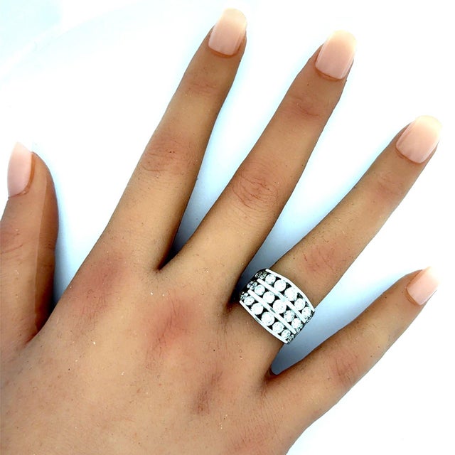 A contemporary fashion ring crafted in 14k white gold, featuring 3 carats of round brilliant-cut white diamonds. The...