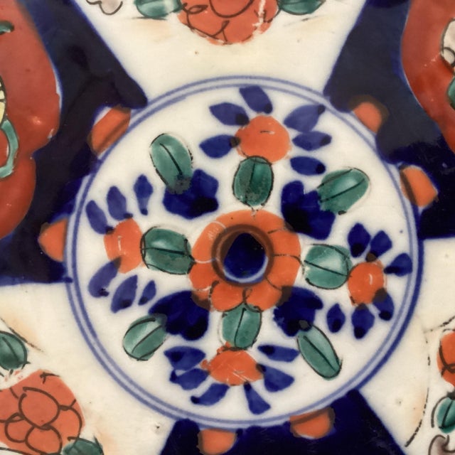 This antique Japanese Imari porcelain plate, dating back to the Meiji period, features hand-painted scalloped edges in...