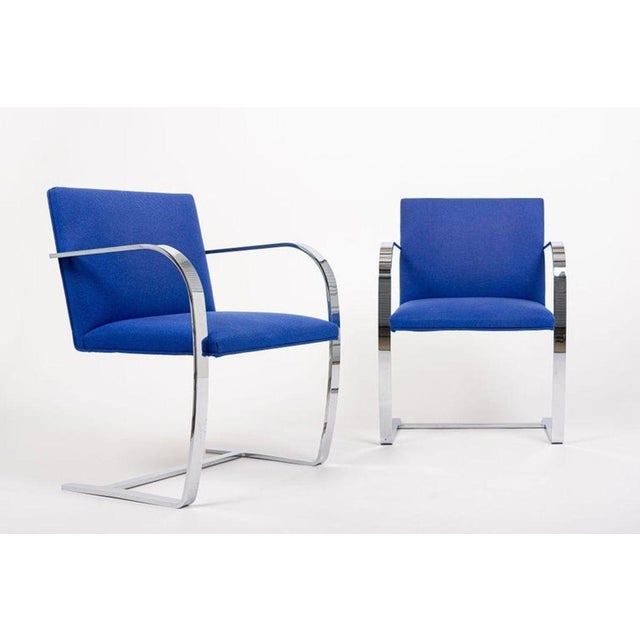 This pair of mid century modern Brno arm chairs by Mies van der Rohe were manufactured by Knoll in 2006. These iconic...