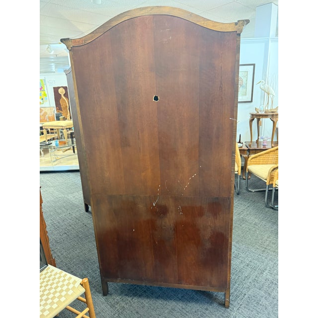 Elevate your space with this stunning pair of antique French Louis XV style armoire. Masterfully crafted from rich, warm,...
