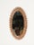Stunning French Riviera–style oval mirror in bamboo, curved rattan, hand-woven wicker, and brass. This stylish and unique...