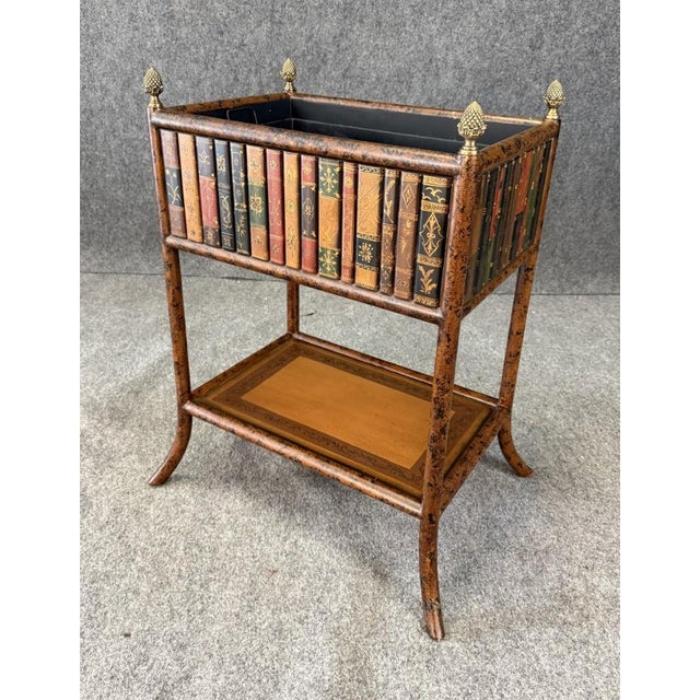 This book-themed plant stand, attributed to Maitland-Smith, features a decorative faux book design around the planter box...