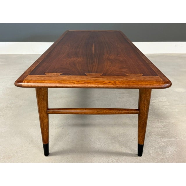 A mid century modern walnut and ash coffee table by Lane Acclaim. Professionally refinished. Made in USA. Dated 1961. 56”...