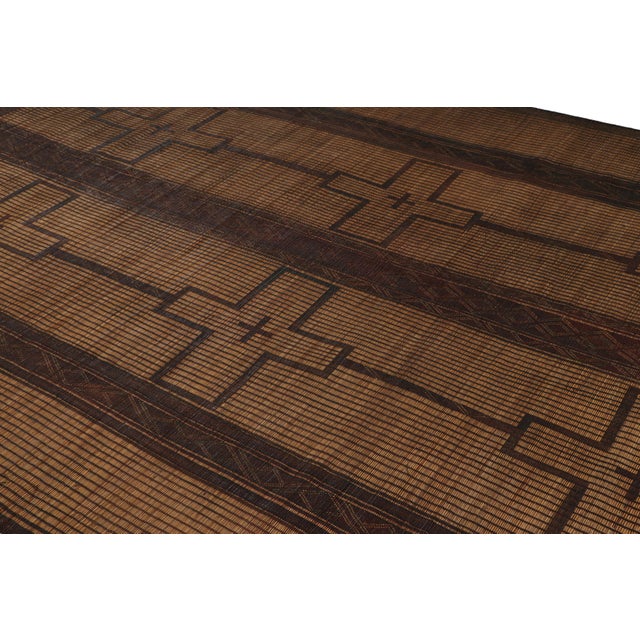 This vintage Moroccan floor covering is a 8x11 Tuareg mat from the nomadic tribe of the same name. Handwoven with reeds...