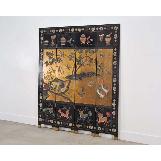 A rich and dramatic Chinese Export folding four-panel double-sided coromandel screen executed in radiant gilt and lacquer....
