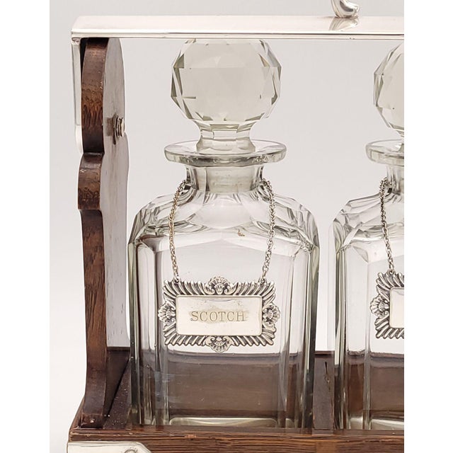 A classic Victorian tantalus with three decanters with labels and a locking case, circa 1870.