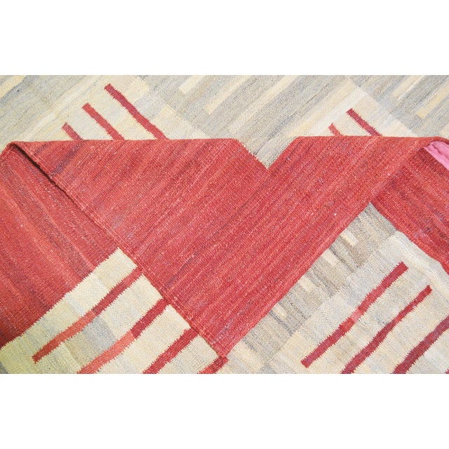 Afghan Modern Flatweave Kilim with care using traditional rug-making techniques, this wool rug blends timeless...