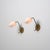Elegant pair of Italian wall sconces manufactured in the 1950s, featuring slender angular brass arms supporting tapered...