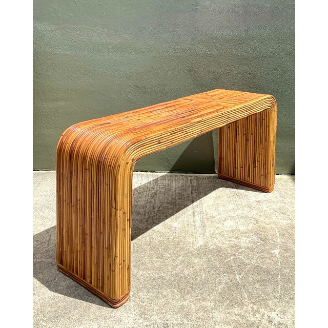 This iconic pencil reed console table is a breathtaking example of 1970s organic modernism, bearing the prestigious...