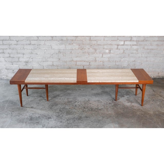 Vintage American of Martinsville walnut and travertine coffee table, circa 1960s. Walnut construction with two travertine...