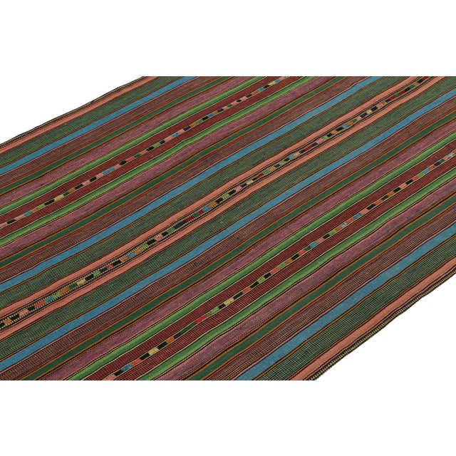 This vintage 5'10''x8' Persian Kilim from Kurdistan employs the distinct “palas” weaving technique. On the Design:...