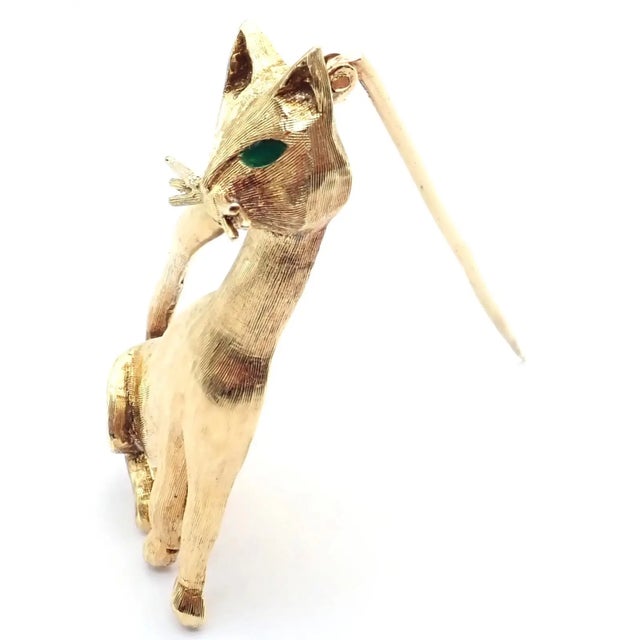This authentic Tiffany & Co. cat brooch is crafted in 18k yellow gold, featuring a sleek sculptural feline form with...